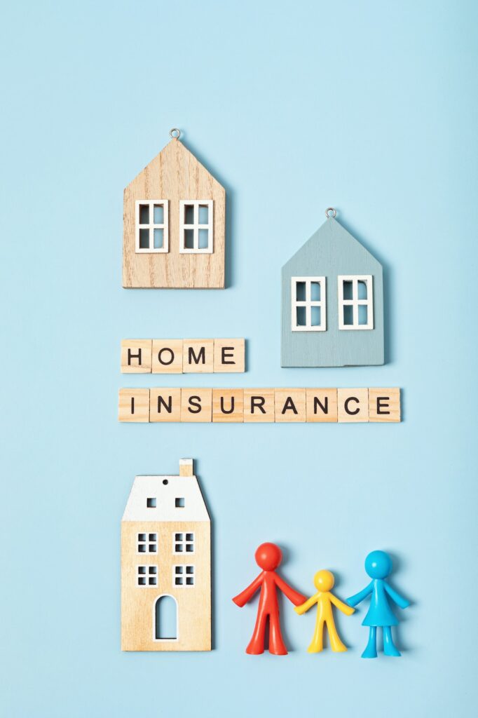 Home insurance message and wooden houses over blue background